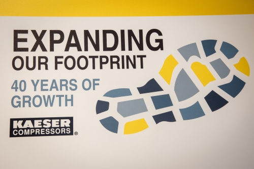 Kaeser Compressors wall graphic reading Expanding Our Footprint, 40 Years of Growth, with a stylised footprint.