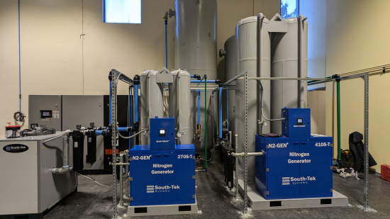 Two South-Tek nitrogen generators installed in a plant room alongside their adsorption vessels and a compressed air supply.