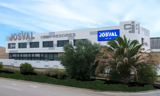 The Josval Compresores headquarters building, with the company name on the facade and palms in the foreground.